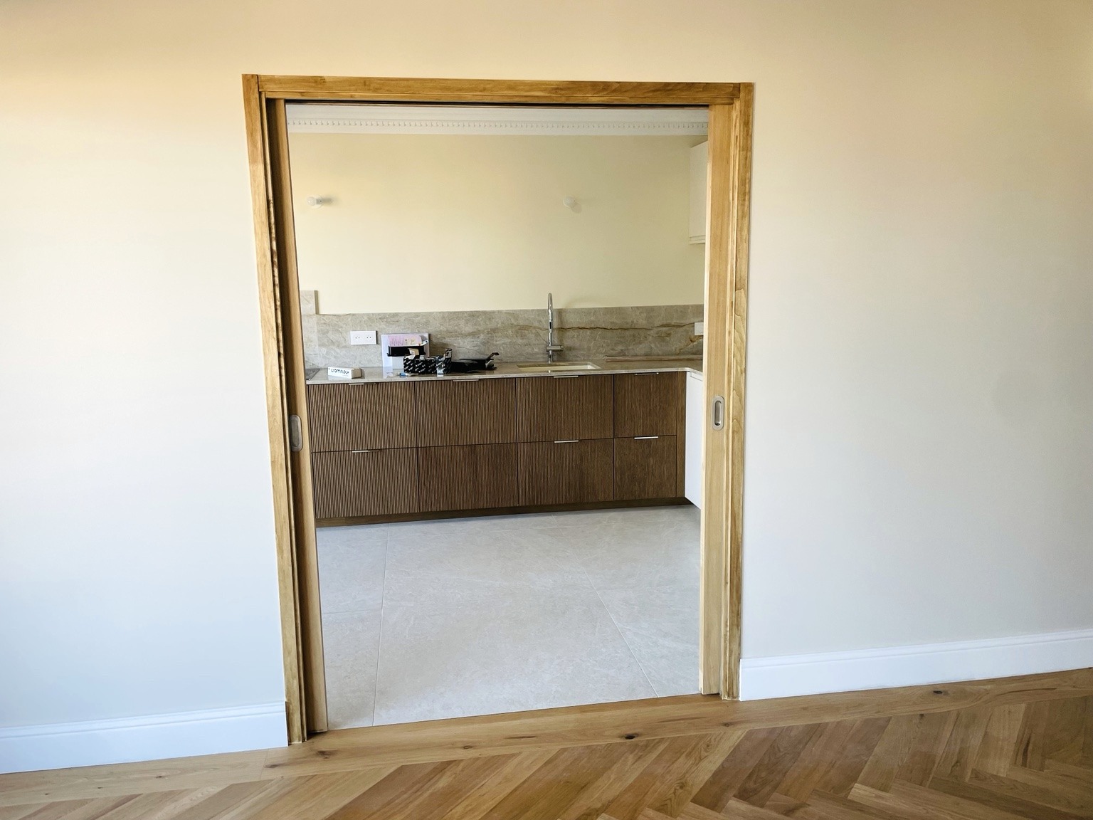 Kitchen and doorway after renovation in Fabron