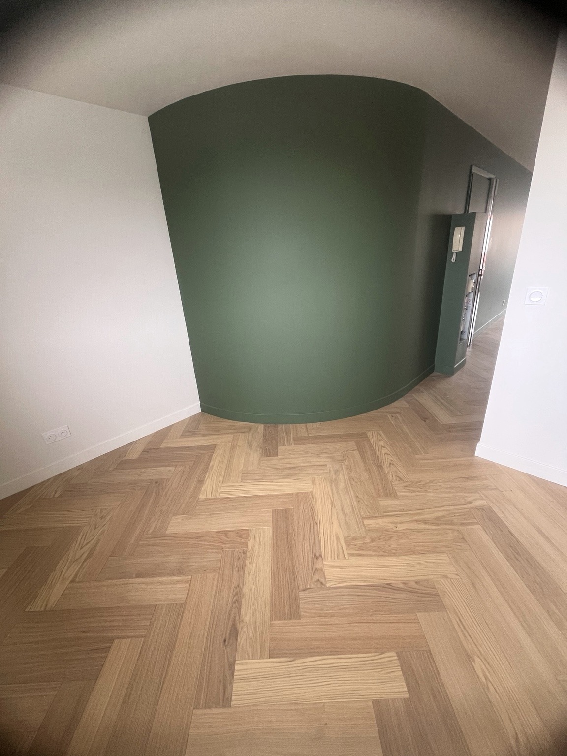 Curved green wall and herringbone wood floor, a NEXUS project